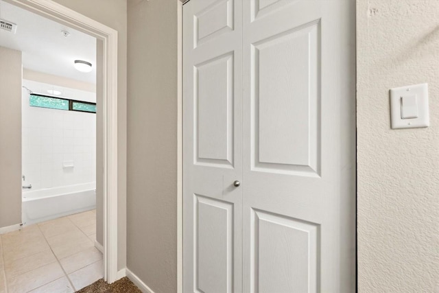 corridor with light tile patterned floors