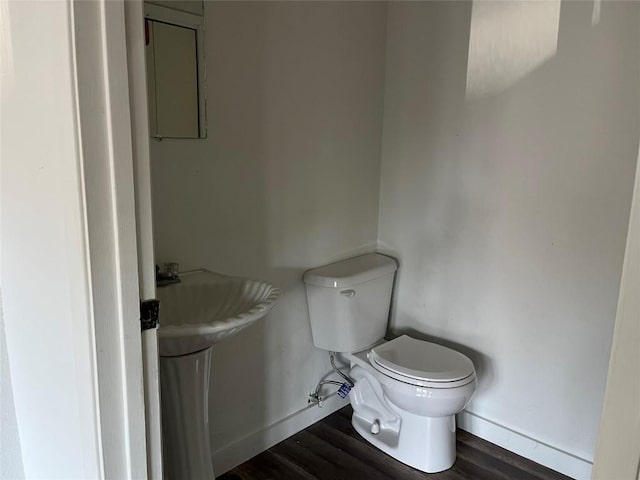 1207 NE Loop 230th Loop, Smithville, TX 78957 - bathroom with baseboards, wood finished floors, and toilet