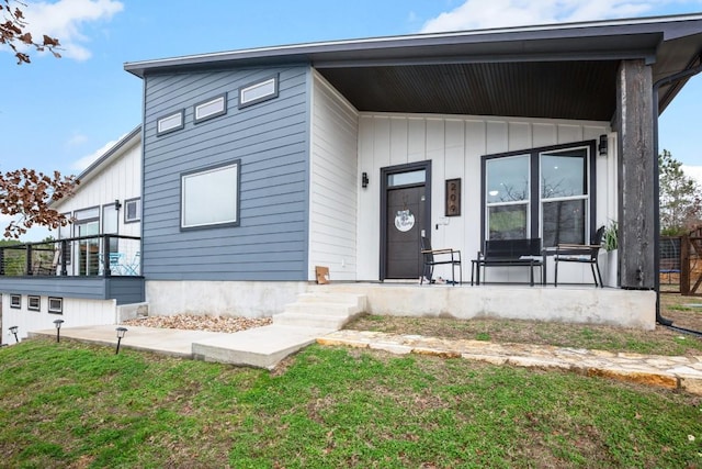 modern home with a porch and a front yard