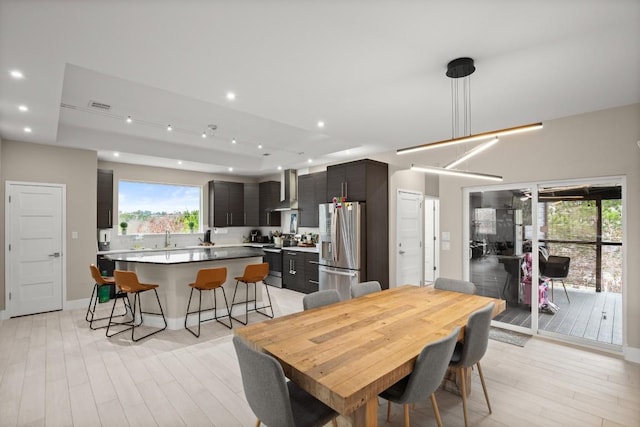 dining area with baseboards, recessed lighting, and light wood-style floors