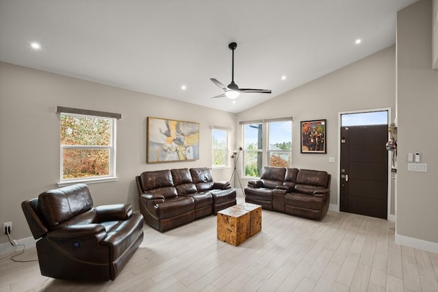 living room with ceiling fan, lofted ceiling, and light hardwood / wood-style flooring