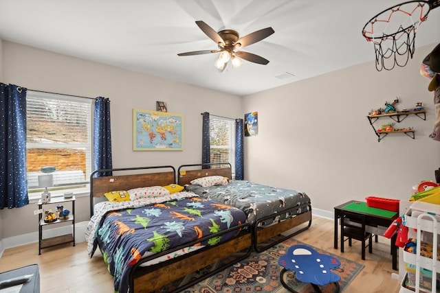 bedroom with ceiling fan and light wood-type flooring