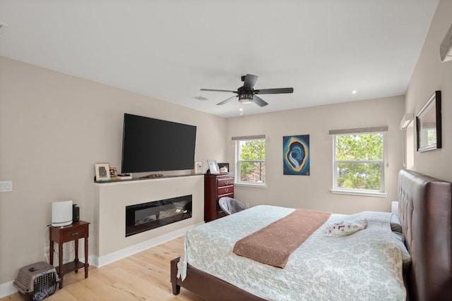 bedroom featuring ceiling fan and light hardwood / wood-style flooring