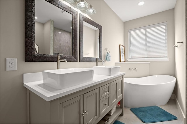 bathroom with vanity and a washtub