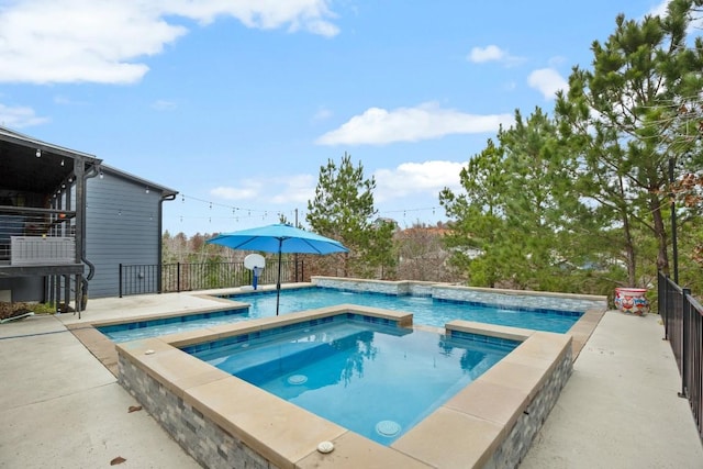 outdoor pool featuring a patio area, fence, and an in ground hot tub