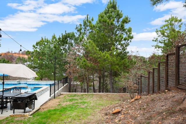 view of yard with a patio area, fence, and a fenced in pool