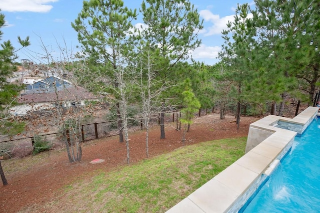 view of yard with fence and a fenced in pool