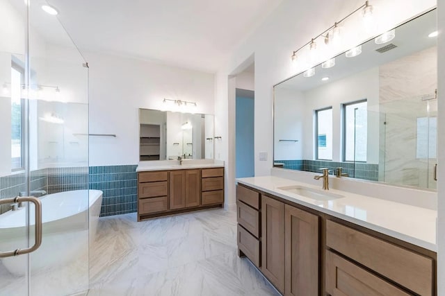 7605 Becasseau Dr, Austin, TX 78738 - full bathroom featuring a sink, a soaking tub, two vanities, and a stall shower