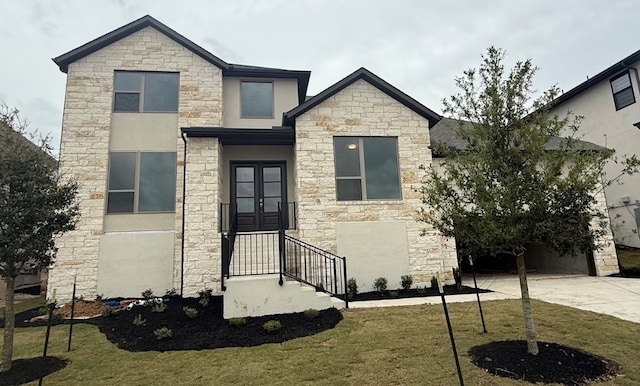 7605 Becasseau Dr, Austin, TX 78738 - view of front of house with french doors, stone siding, concrete driveway, stucco siding, and a front lawn