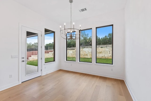 7605 Becasseau Dr, Austin, TX 78738 - unfurnished dining area featuring an inviting chandelier, plenty of natural light, visible vents, and light wood-style flooring