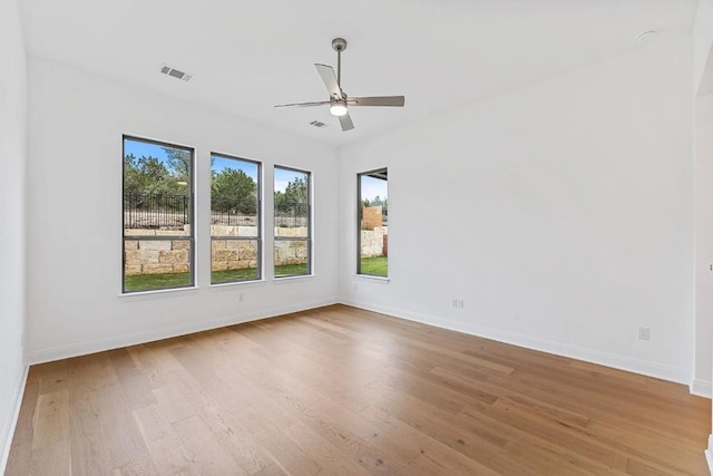 7605 Becasseau Dr, Austin, TX 78738 - unfurnished room with baseboards, visible vents, wood finished floors, and a ceiling fan