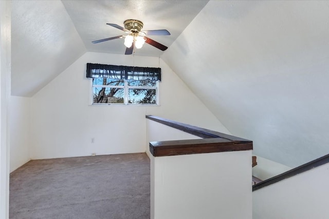 bonus room with ceiling fan, lofted ceiling, and carpet floors