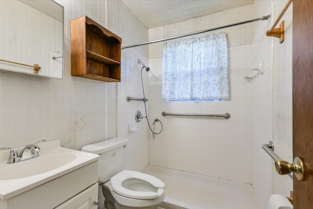 bathroom featuring tile walls, vanity, tasteful backsplash, a tile shower, and toilet