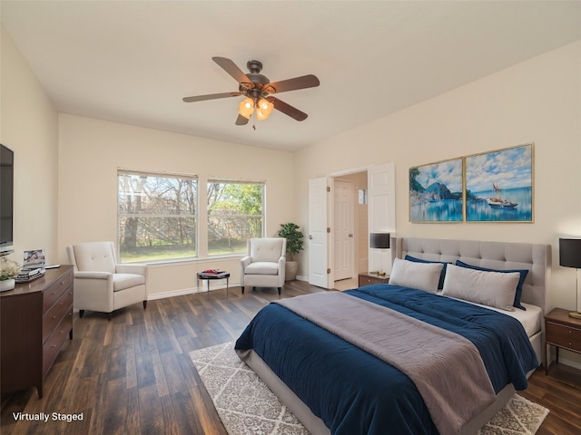 bedroom with dark hardwood / wood-style flooring and ceiling fan