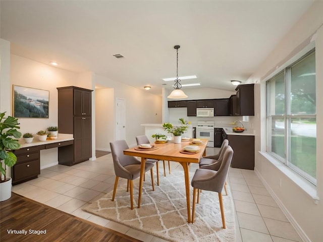 1416 Thibodeaux Dr, Round Rock, TX 78664 - dining room with lofted ceiling, light tile patterned floors, and baseboards