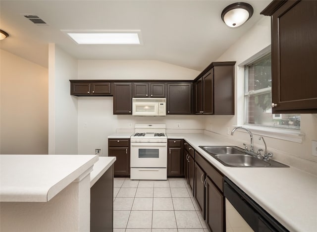 1416 Thibodeaux Dr, Round Rock, TX 78664 - kitchen featuring white appliances, lofted ceiling, dark brown cabinetry, and light tile patterned floors