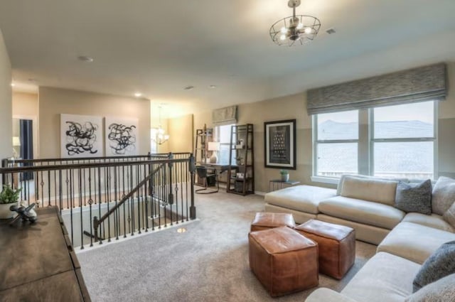 living room with an inviting chandelier and light carpet