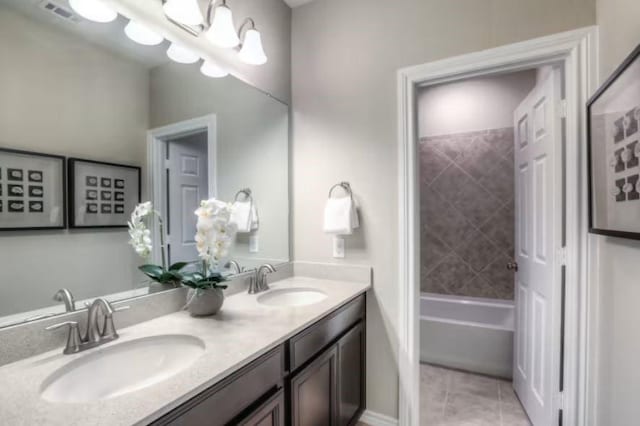 bathroom featuring tile patterned floors, vanity, and a chandelier