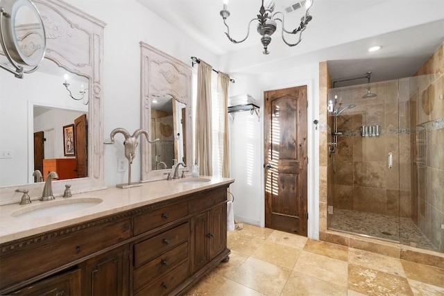 bathroom featuring a chandelier, vanity, and an enclosed shower