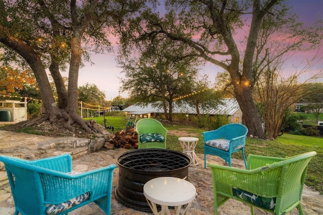 patio terrace at dusk featuring a fire pit