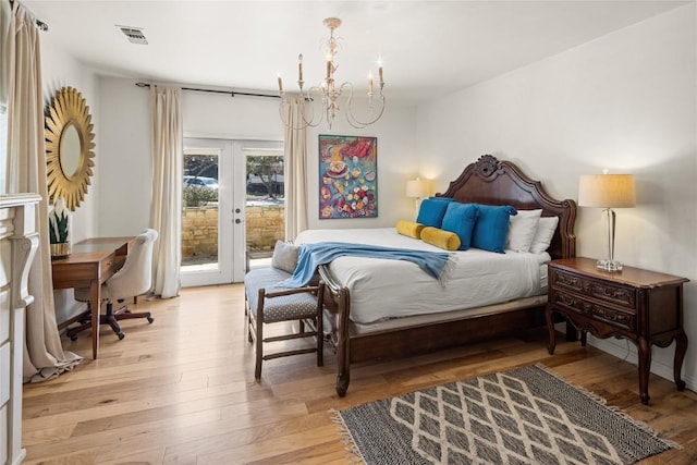 bedroom featuring french doors, a chandelier, access to outside, and light wood-type flooring