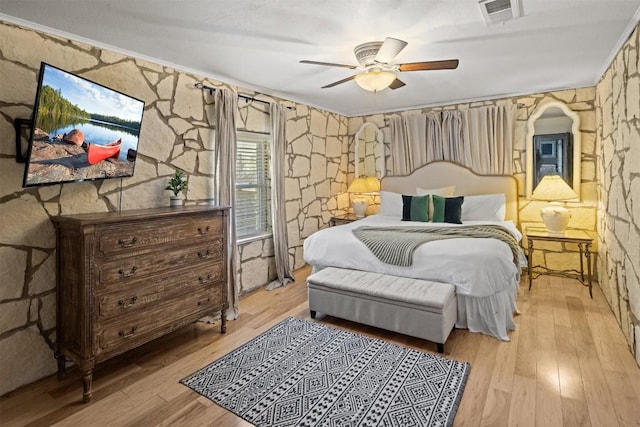 bedroom with light hardwood / wood-style flooring and ceiling fan