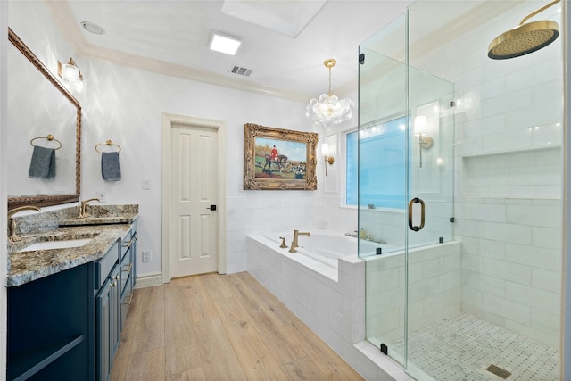 bathroom featuring vanity, hardwood / wood-style floors, crown molding, and shower with separate bathtub