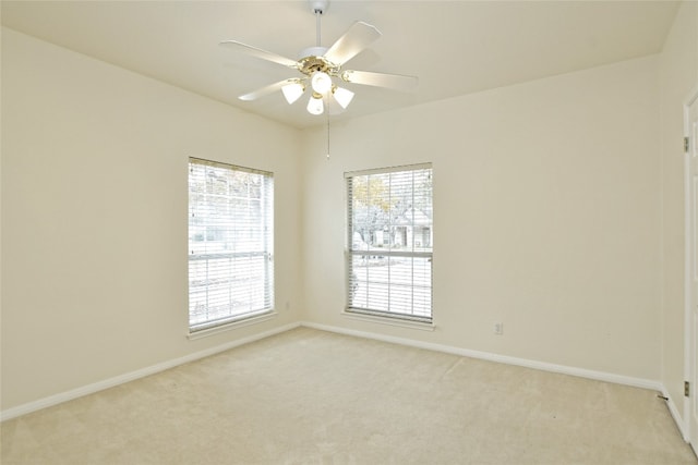 carpeted empty room featuring ceiling fan