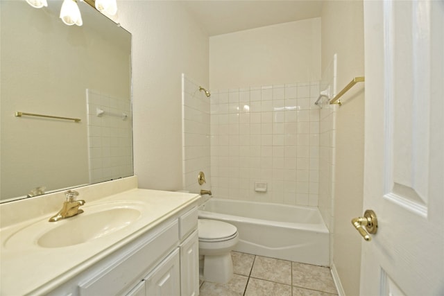 full bathroom with vanity, tiled shower / bath, tile patterned floors, and toilet