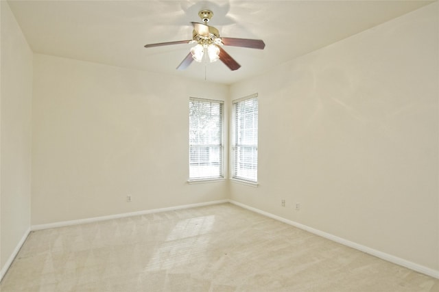 carpeted spare room with ceiling fan