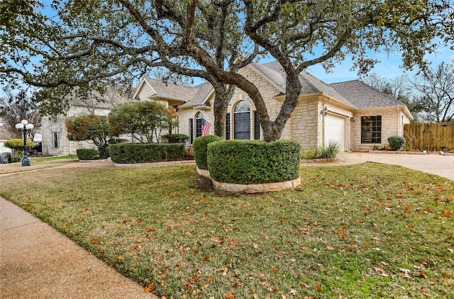 view of front of house featuring a garage and a front lawn