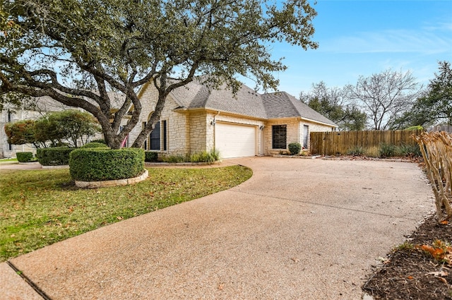 ranch-style home with a garage and a front yard