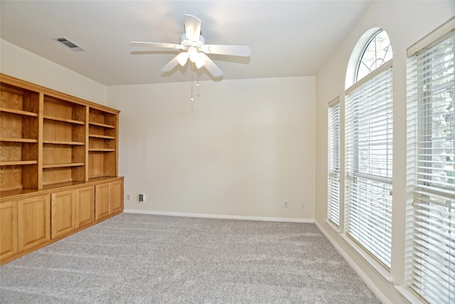 interior space with light carpet and ceiling fan