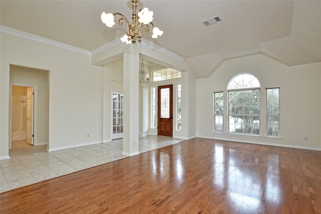 entryway featuring a notable chandelier, a wealth of natural light, and light wood-type flooring