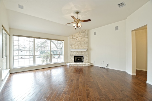 unfurnished living room with vaulted ceiling, dark hardwood / wood-style floors, ceiling fan, and a fireplace