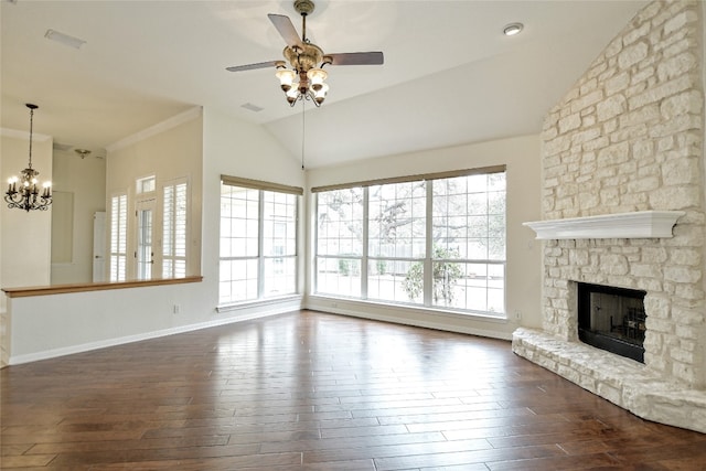 unfurnished living room featuring ceiling fan with notable chandelier, a fireplace, dark hardwood / wood-style flooring, and vaulted ceiling