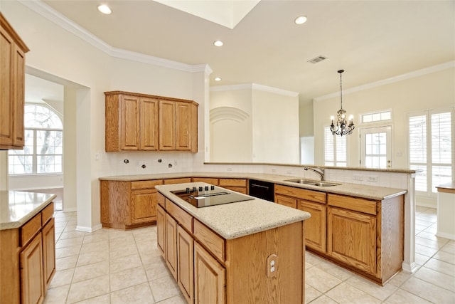 kitchen with a kitchen island, kitchen peninsula, decorative light fixtures, sink, and black appliances