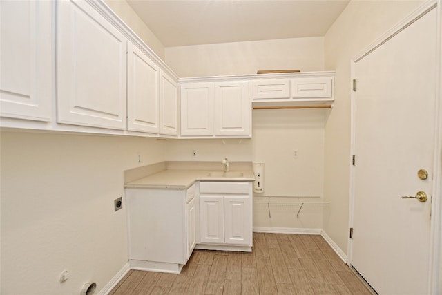 laundry room featuring sink, cabinets, hookup for an electric dryer, and light wood-type flooring