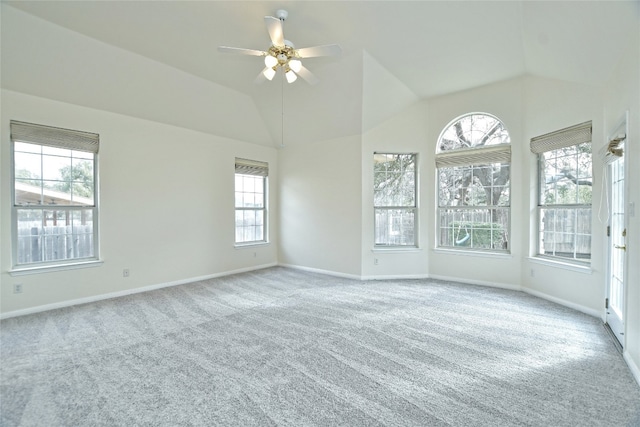 spare room featuring lofted ceiling, light colored carpet, and ceiling fan