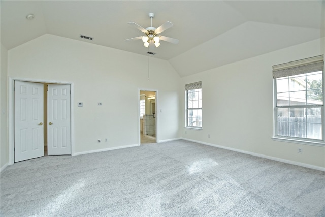 unfurnished room with light carpet, vaulted ceiling, and ceiling fan