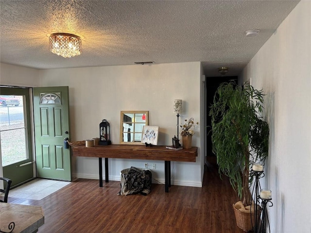 foyer with wood-type flooring and a textured ceiling