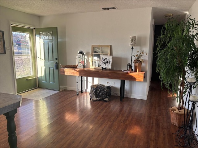 entryway featuring hardwood / wood-style floors and a textured ceiling