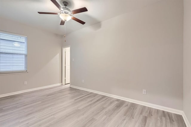 spare room with ceiling fan and light wood-type flooring