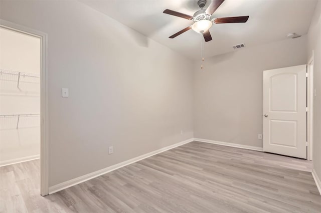 unfurnished room with ceiling fan and light wood-type flooring