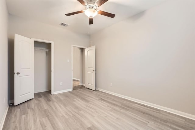 unfurnished bedroom with ceiling fan, light hardwood / wood-style floors, and a closet