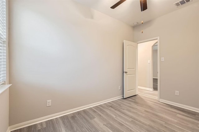 spare room with ceiling fan and light wood-type flooring