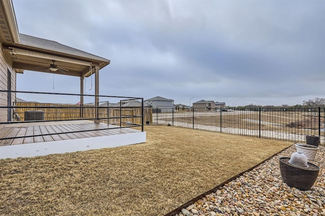 view of yard featuring a water view and ceiling fan