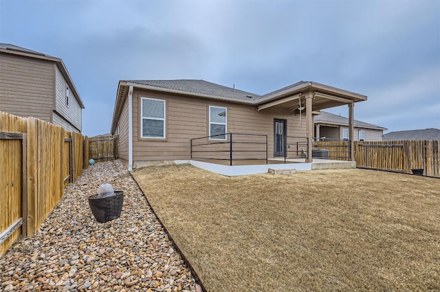 rear view of house featuring ceiling fan