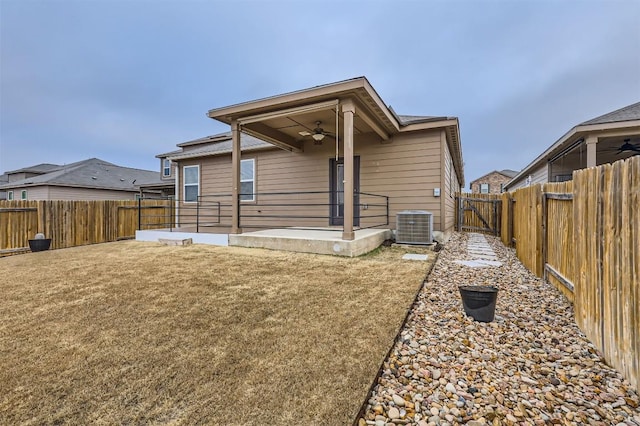 rear view of property featuring central AC, a patio, ceiling fan, and a lawn