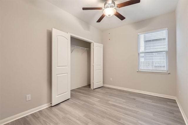 unfurnished bedroom featuring light hardwood / wood-style floors, a closet, and ceiling fan